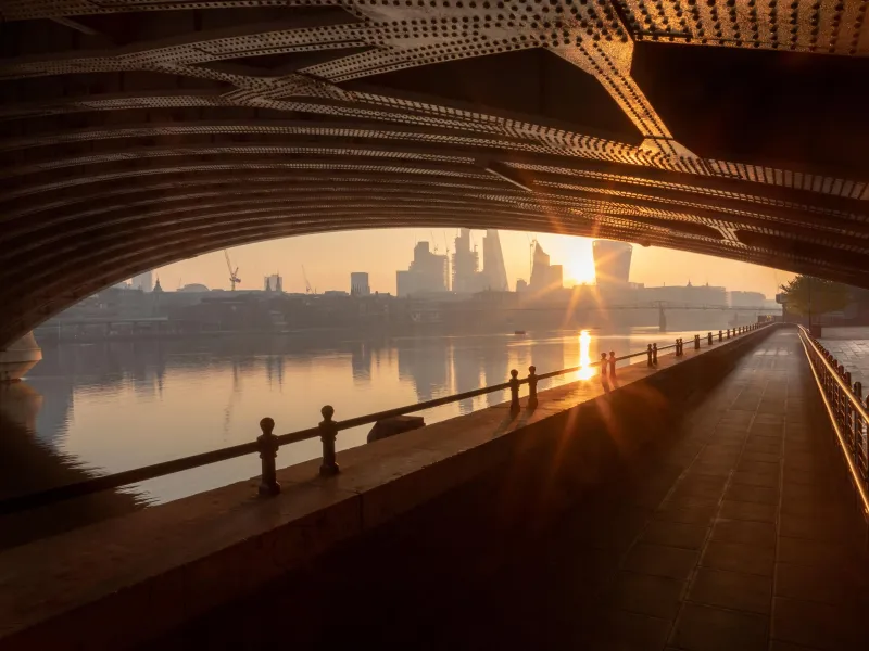 City scape viewed from under a bridge at sunset