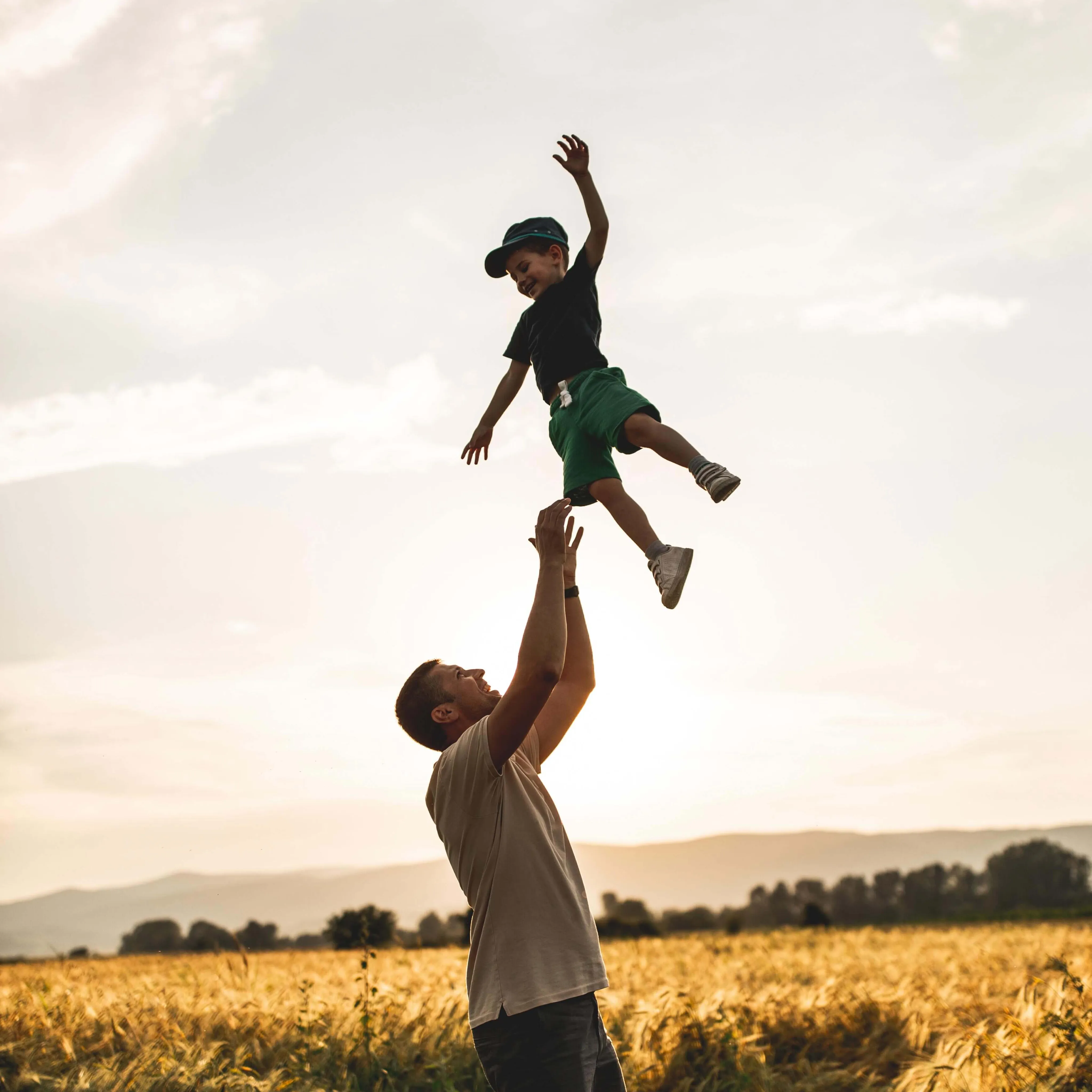 Father throwing child in the air