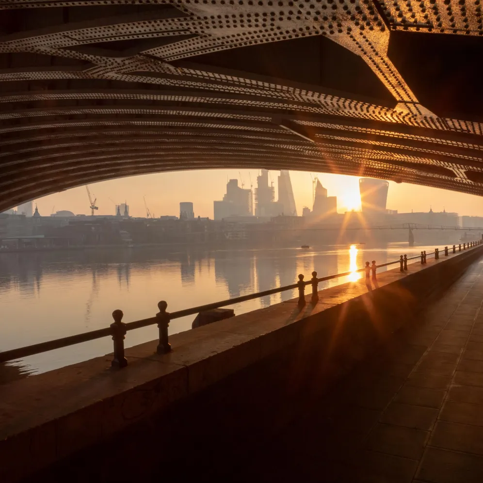 City scape viewed from under a bridge at sunset